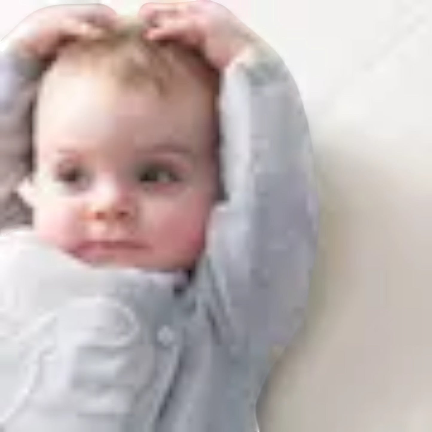 Modugreen Baby breathable organic cotton crib mattress cover with a quilted surface, shown with a happy baby.