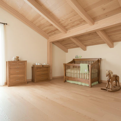Nursery room with wooden furniture and toys on a wooden floor.