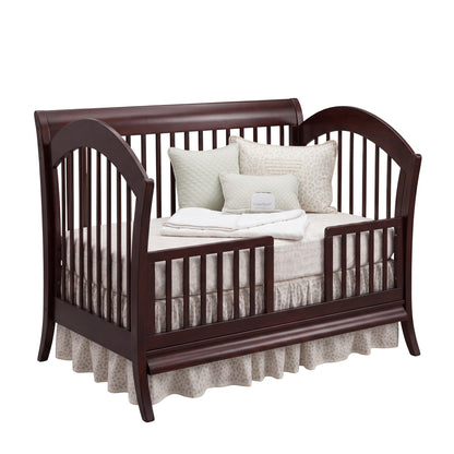 Modugreen Baby Laurel conversion kit transforming a dark wood slat crib into a stylish toddler bed with safety rail.