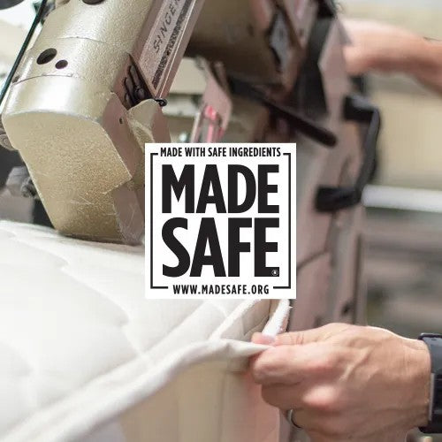 Modugreen Baby Lullaby Earth crib mattress being sewn with MADE SAFE certification label visible