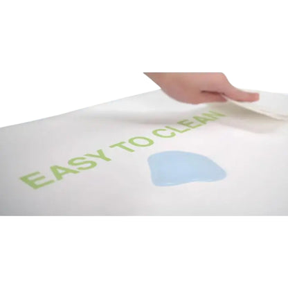 Modugreen Baby Lullaby Earth crib mattress with a waterproof, wipe-clean surface being cleaned by a hand.