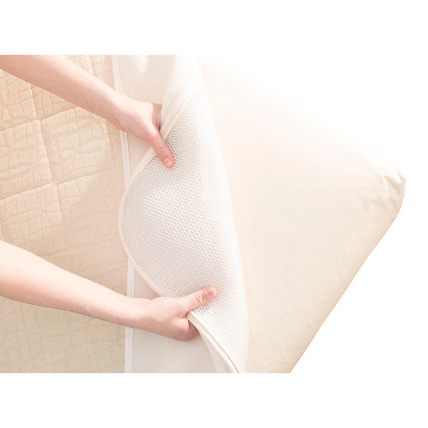 Modugreen Baby organic crib mattress with a removable, quilted 3D lattice breathable cover being peeled back.