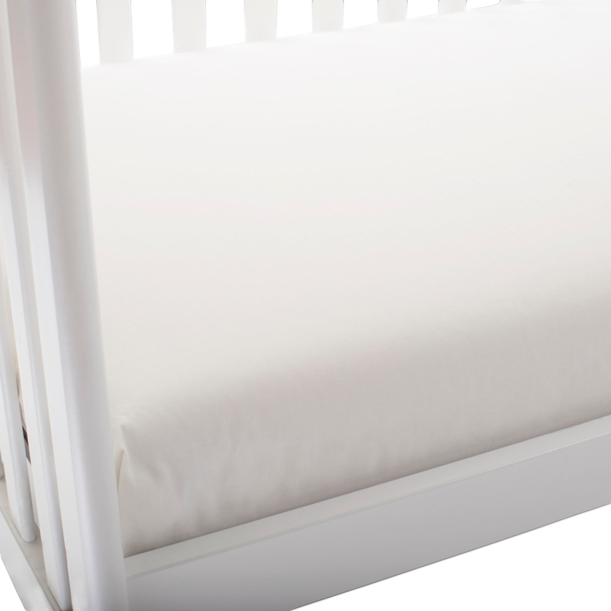 Modugreen Baby lightweight organic cotton 2-stage crib mattress in white, featuring a waterproof, non-toxic surface.