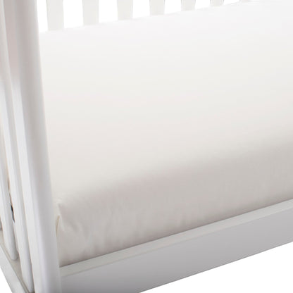 Modugreen Baby lightweight organic cotton 2-stage crib mattress in white, featuring a waterproof, non-toxic surface.
