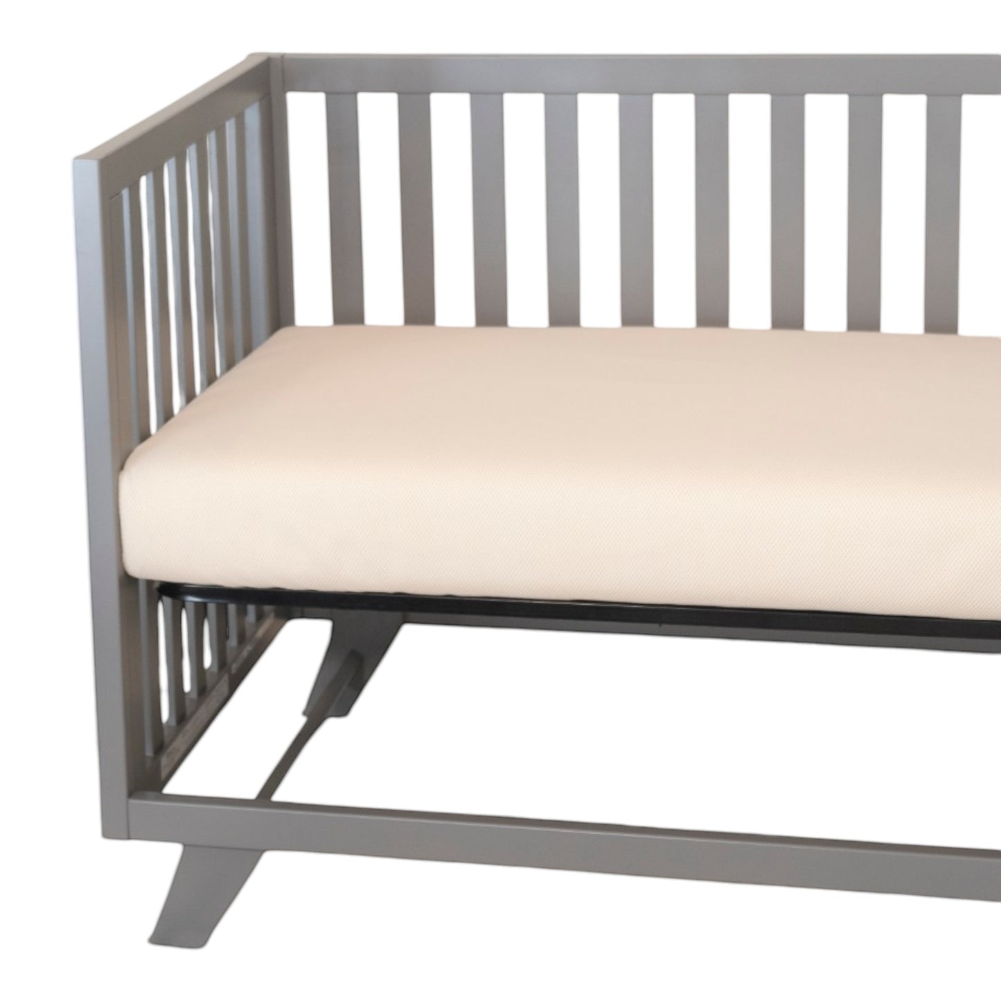 Modugreen Baby breathable organic 2-stage crib mattress with cream 3D mesh cover inside a modern grey wooden crib.