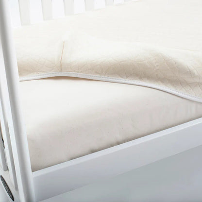 Modugreen Baby breathable organic cotton crib mattress cover with a quilted 3D lattice surface in cream.