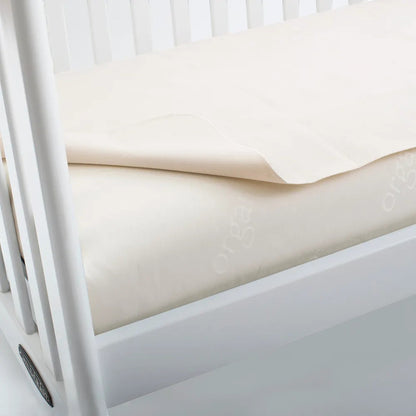 Modugreen Baby flat organic cotton crib mattress protector pad in cream, featuring a soft, breathable design.