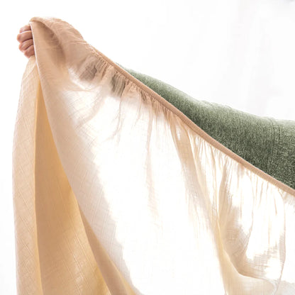 Modugreen Baby organic cotton muslin crib sheet in a soft sand color, showing the textured, breathable double-layer.