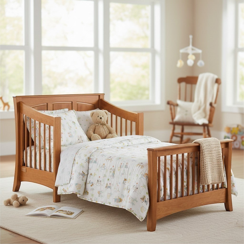 Modugreen Baby Sylvan Conversion Kit for Panel Crib in natural wood finish, converting to a toddler bed with bedding and teddy bear.