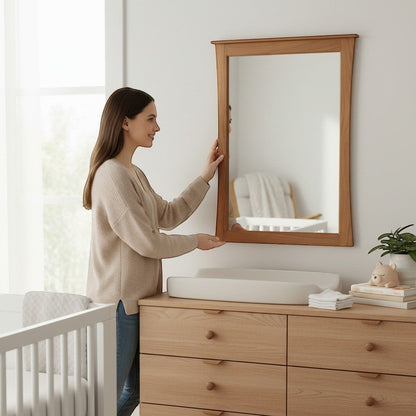 Modugreen Baby Sylvan Mirror with a solid hardwood frame and bowed edges, mounted above a wooden nursery dresser.